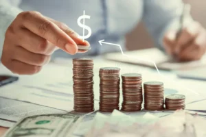 Holding Cash vs. 3.3% GDP Growth: How Inflation Erodes Idle Savings business woman hand holding coins to stack desk concept saving money finance 150731429