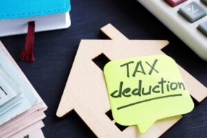 property tax deduction. model of house and calculator.